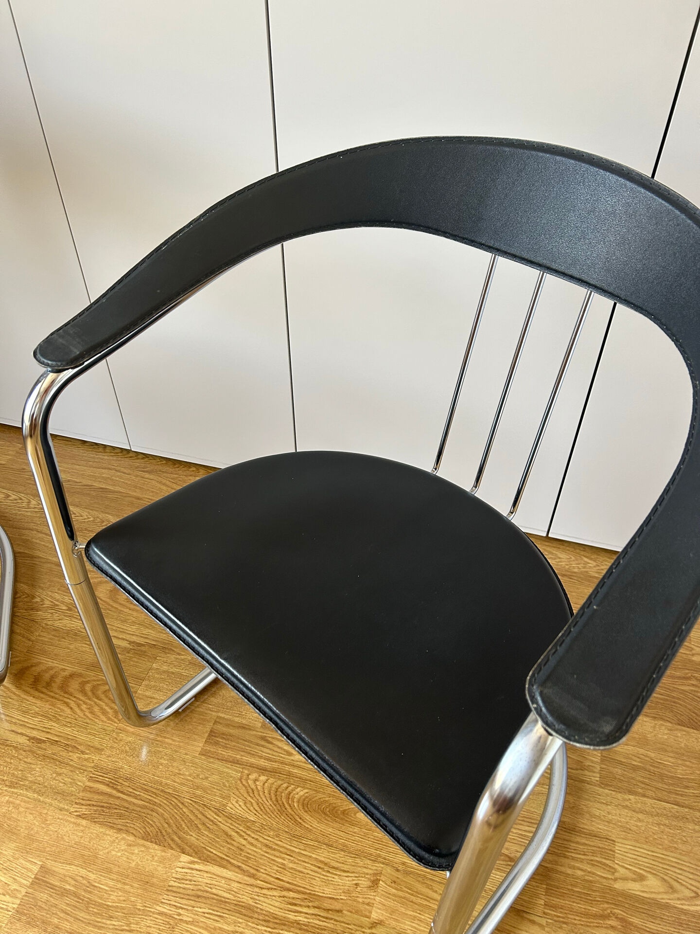Space Age chairs in black leather and chrome metal