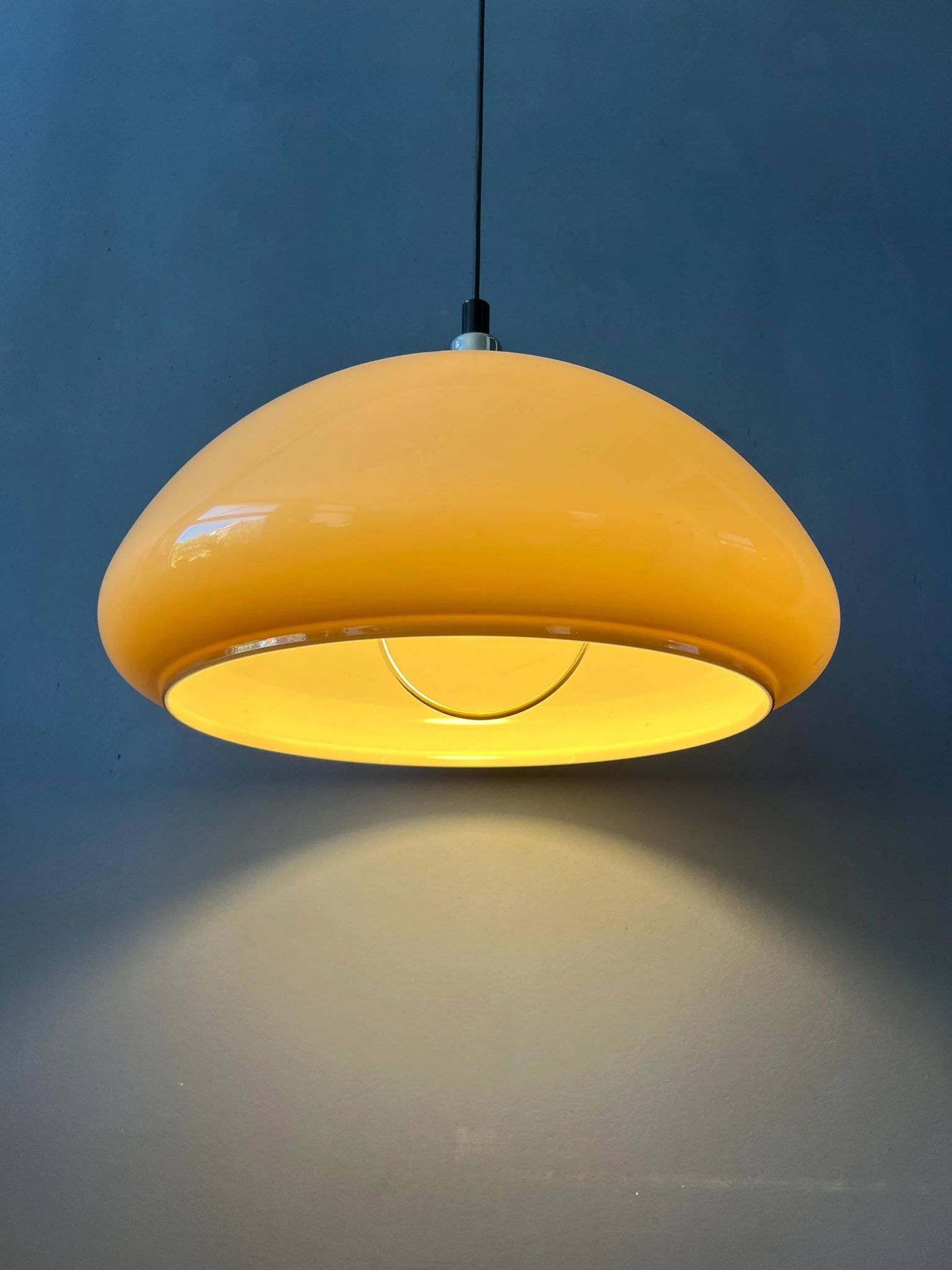 Beige acrylic glass mushroom pendant with a chrome top cap.