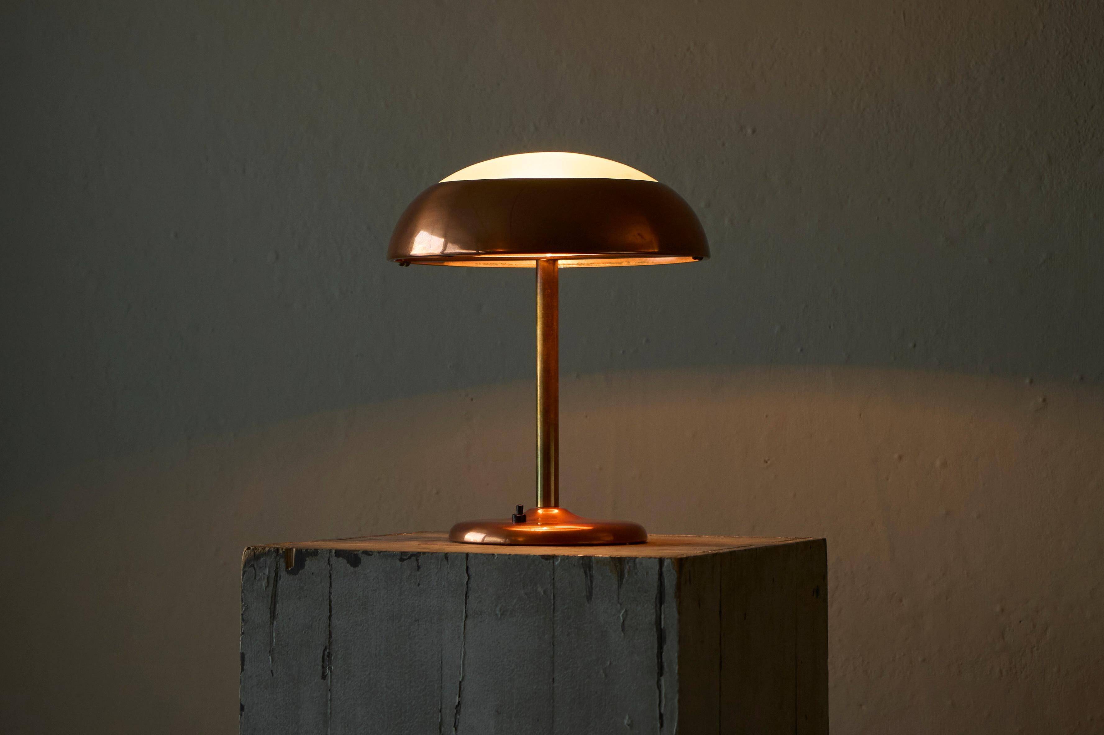 Art Deco table lamp in patinated copper, brass, and satin glass from the 1950s.