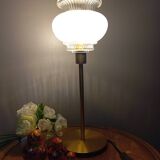 Table lamp with gold metal base and vintage white glass lampshade