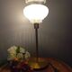 Table lamp with gold metal base and vintage white glass lampshade