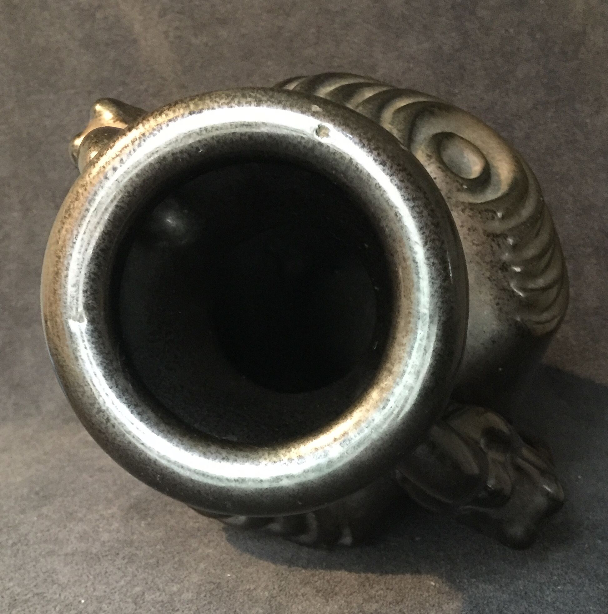 Black ceramic vase caught in naked women's bodies