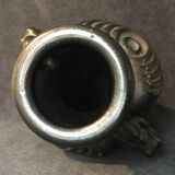 Black ceramic vase caught in naked women's bodies