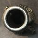 Black ceramic vase caught in naked women's bodies