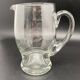 Glass jug with chiseled pattern