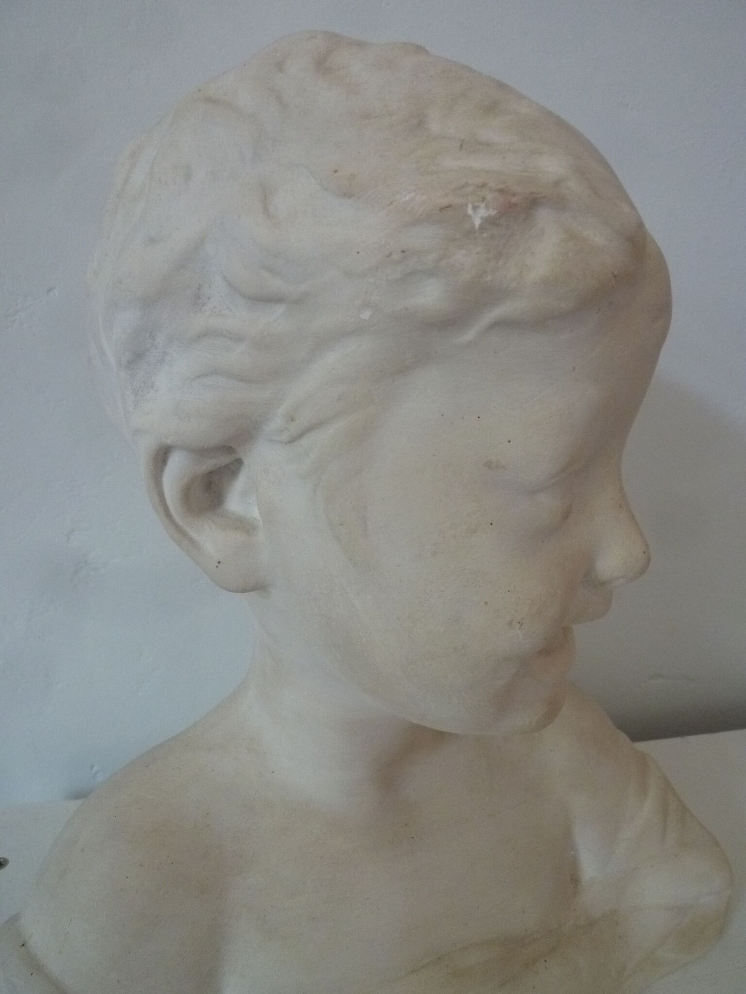Bust young boy in plaster