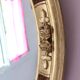 Antique medallion mirror with a gilded and relief-carved frame.