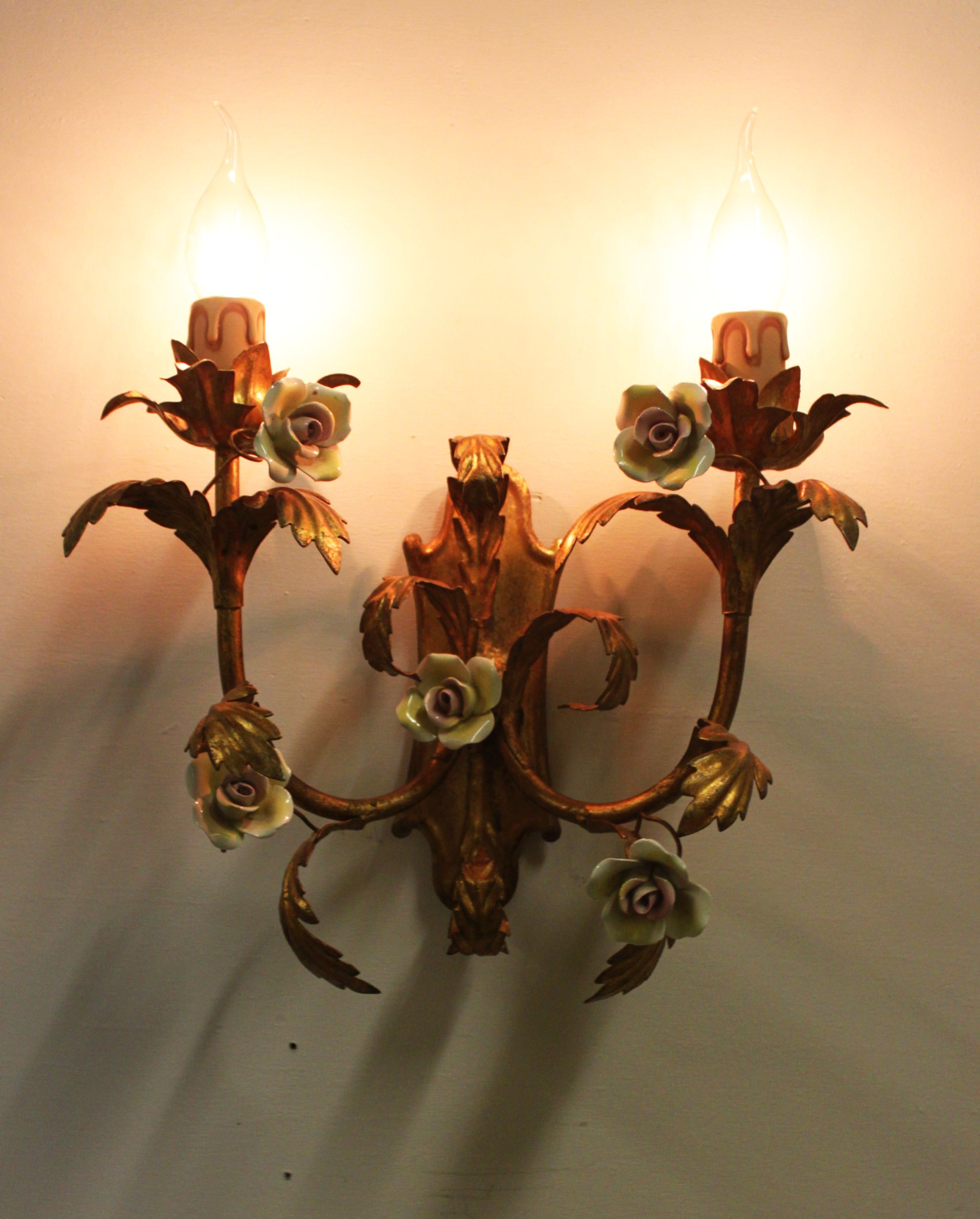 Pair of gold wall sconces with porcelain flowers