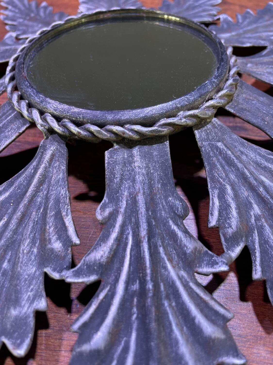 Metal mirror with foliage decoration