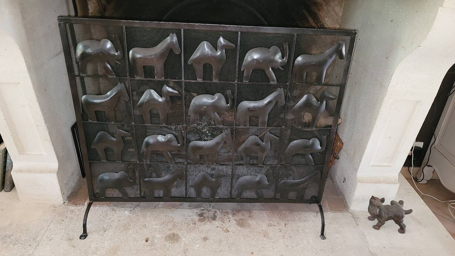 Black metal firewall decorated with animals