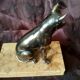 Greenhouse book dog sculpture regulates on marble slab