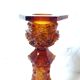 Paire de flambeaux en verre ambré ornés de motifs gothiques