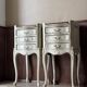 A pair of distressed bedside tables.