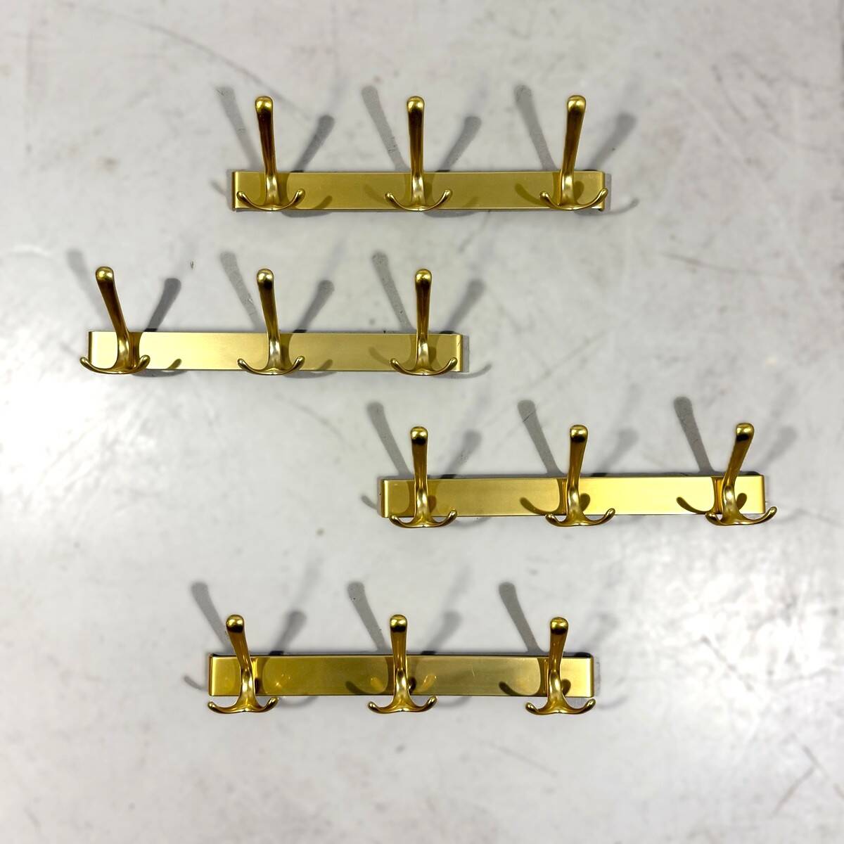 Gold coloured aluminium wall coat racks 1960’s