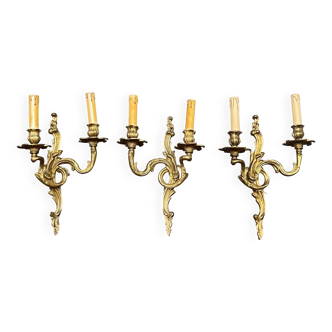 Set of three bronze wall sconces.