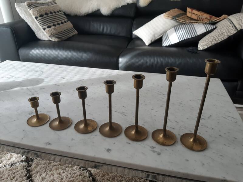 Set of 7 vintage brass candlesticks.