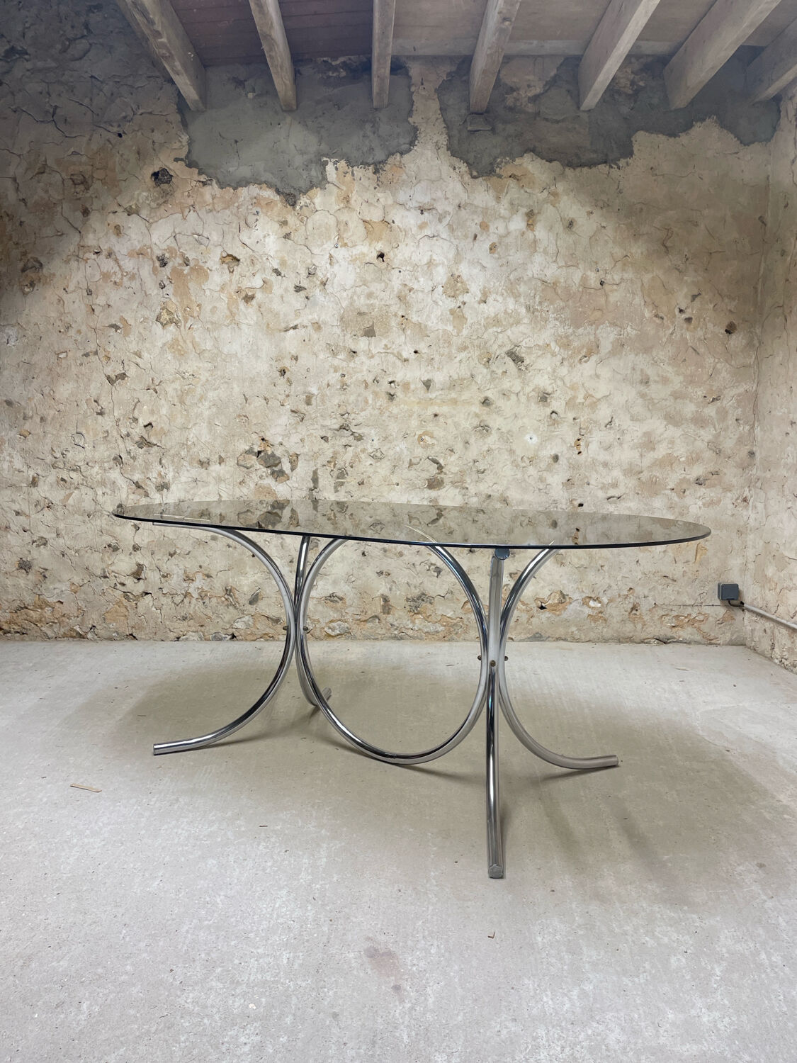 Smoked glass oval table from the 1970s.