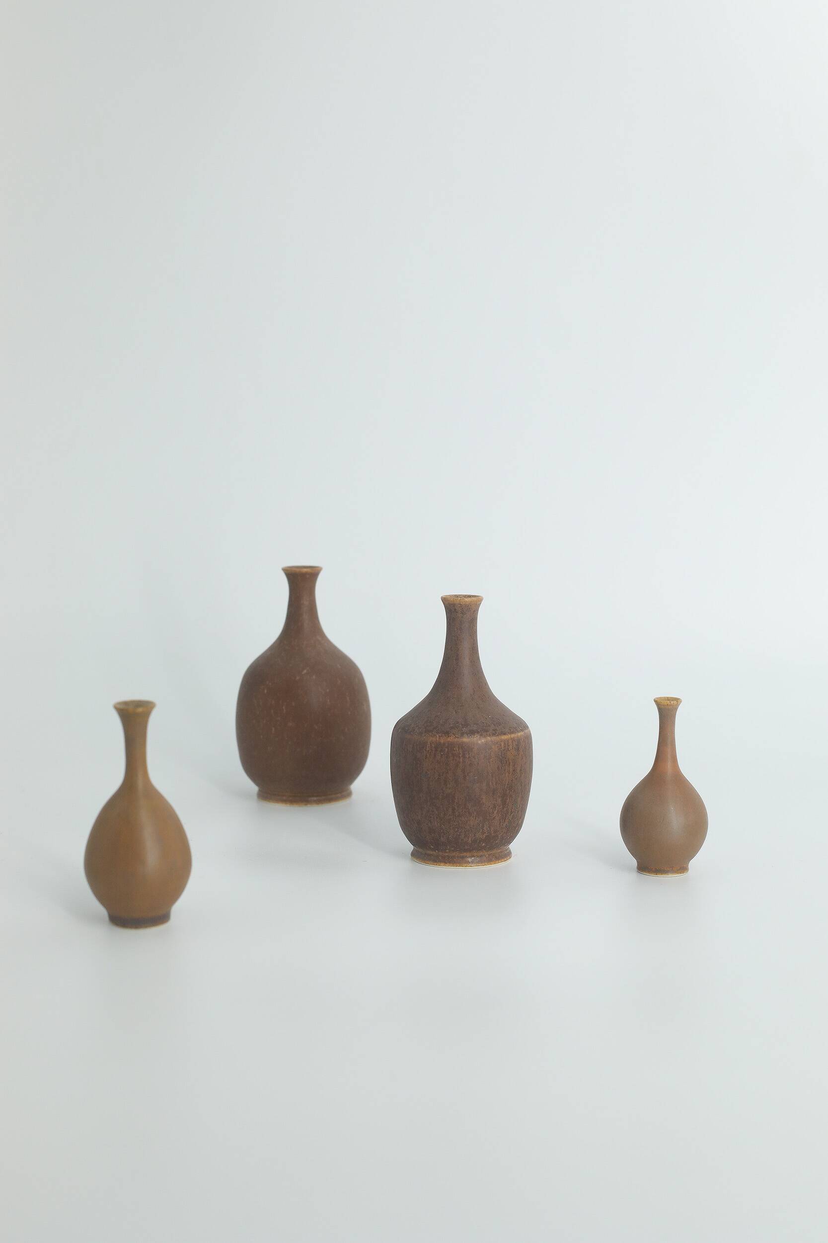 Set of 4 Scandinavian collectible vases in brown stoneware by Gunnar Borg.