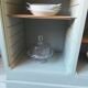 Vintage furniture transformed into a bookcase, verdigris patinated sideboard.
