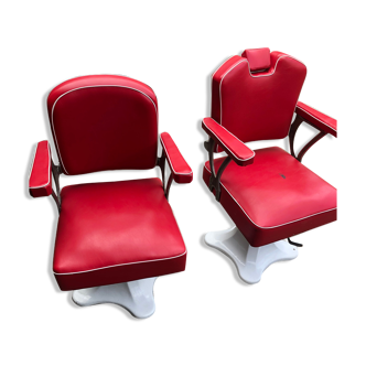 Pair of barber's chairs, enamelled foot