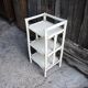 Antique white rattan bedside shelf
