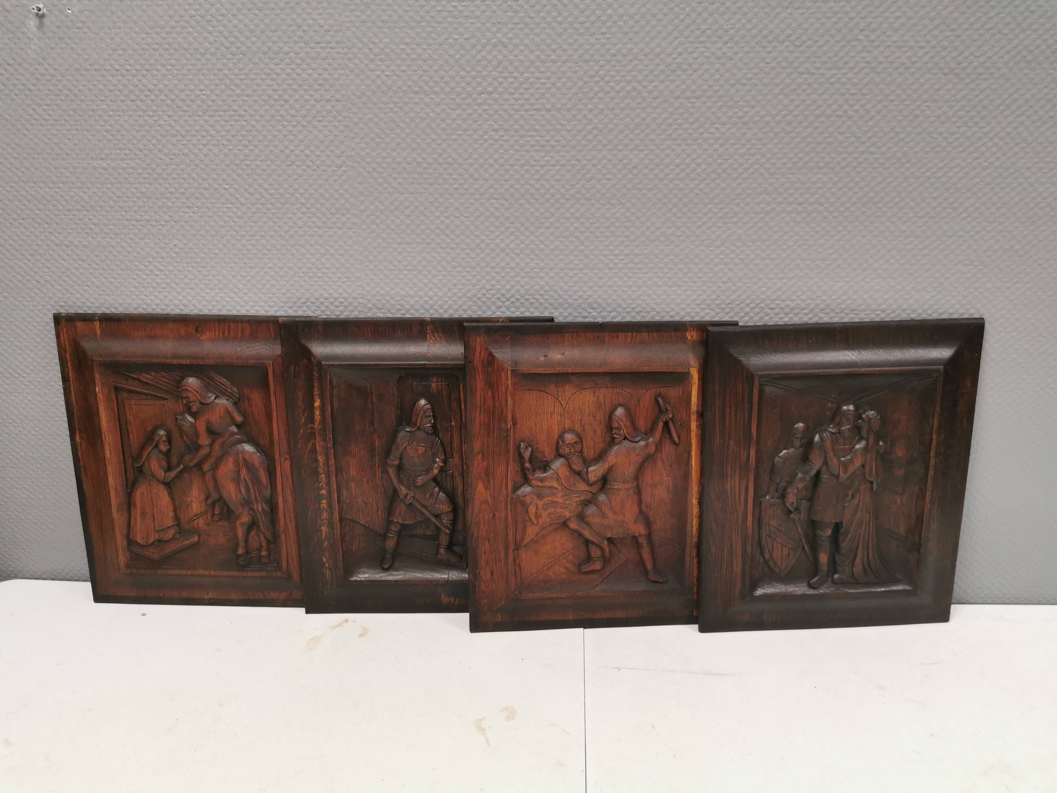 Four old wooden carvings to hang on the wall.