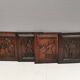 Four old wooden carvings to hang on the wall.