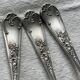Set of 12 small silver-plated metal spoons in Art Nouveau style.