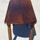 Walnut drop-leaf table with honey spoon legs.