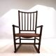 Fauteuil Manou en rotin et assise en cuir, 1960