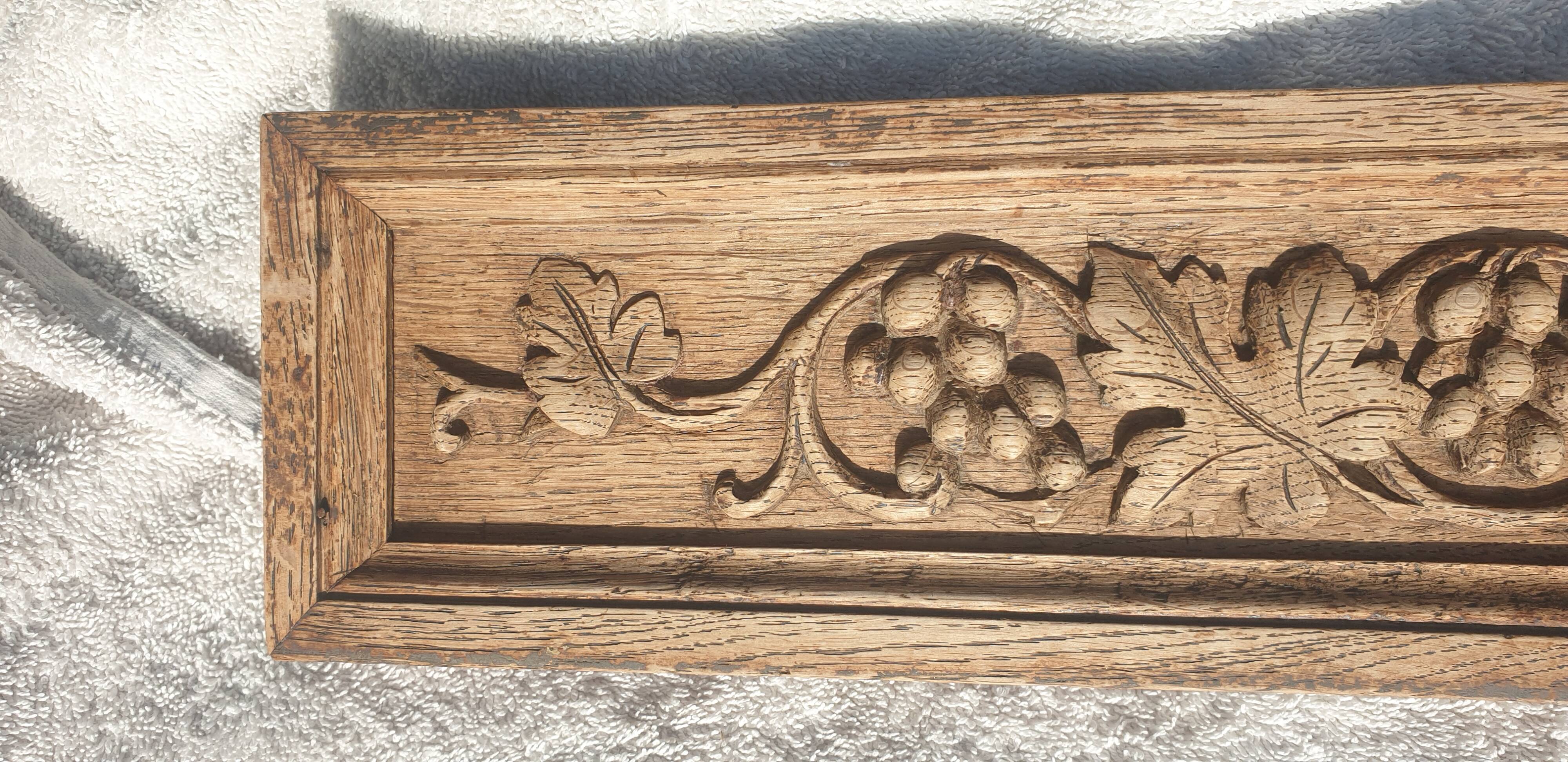 Carved wooden pediment with bunches of grapes