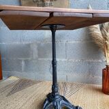 Bistro table with central cast iron leg and rustic top