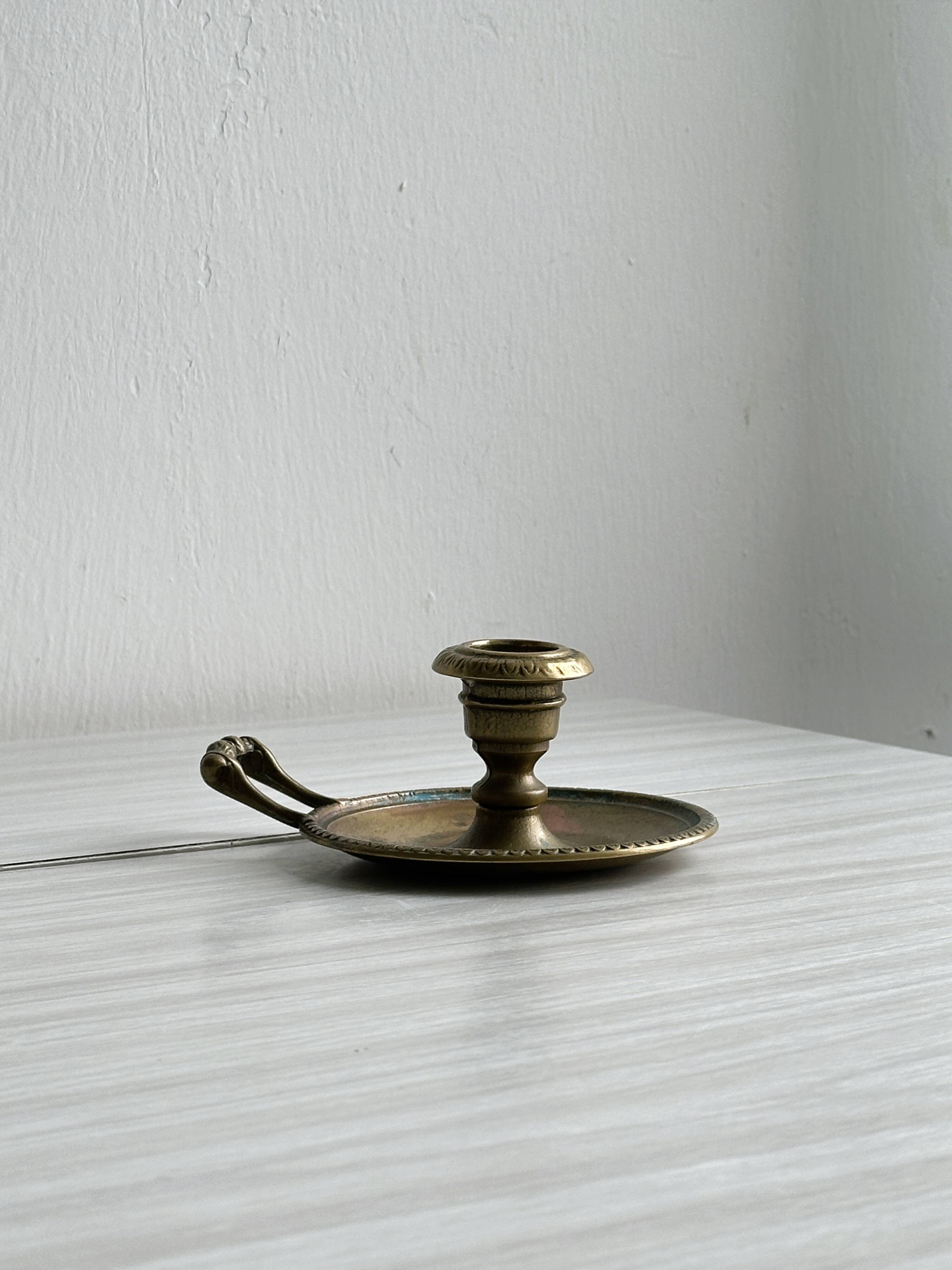 Brass candle holder with handle.