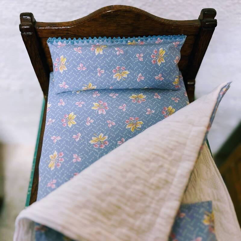 Old doll's bed in varnished wood