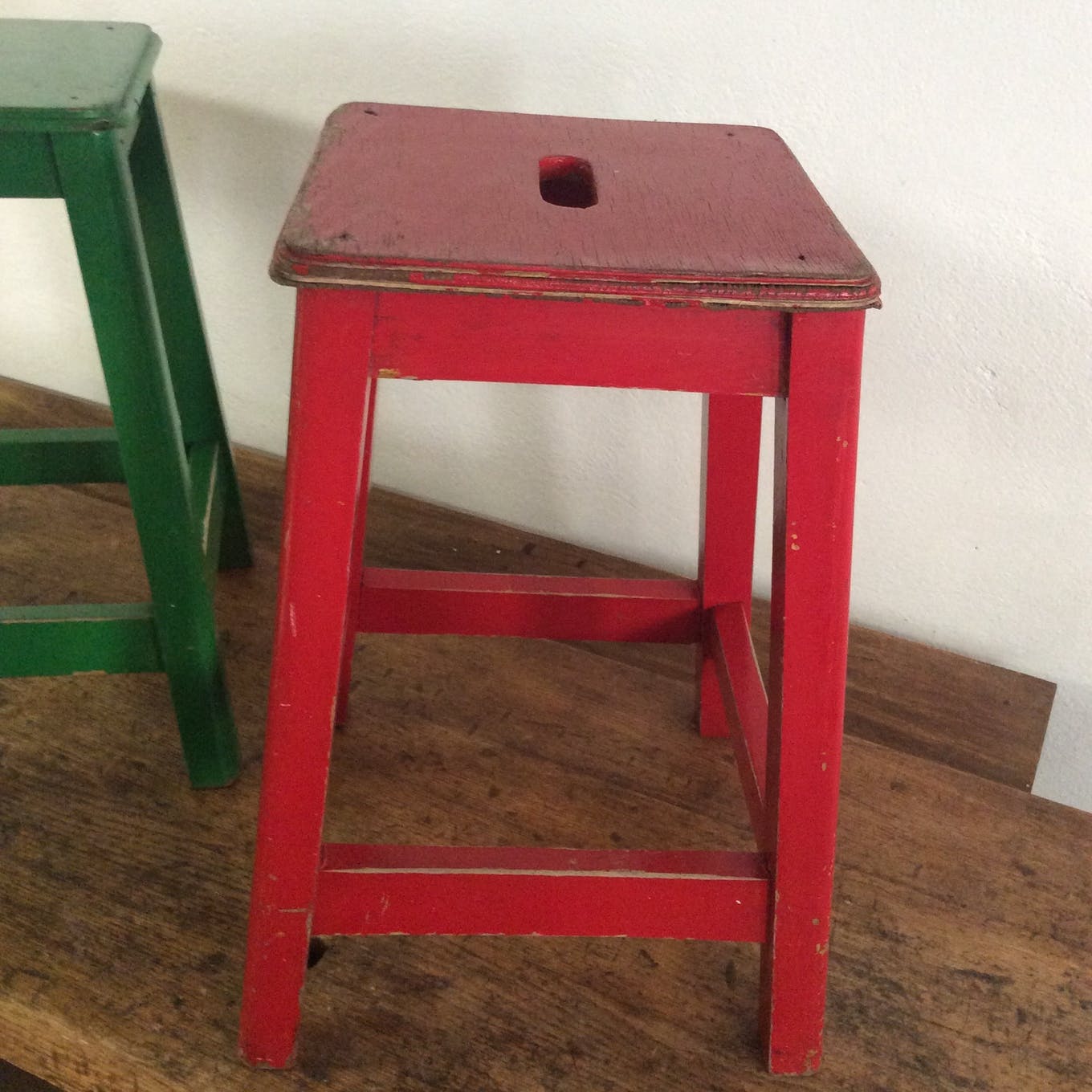 Three wooden stools with a handle