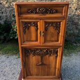 Art Deco sideboard bar cabinet in solid walnut with 3 doors and 1 richly carved tilting false drawer.