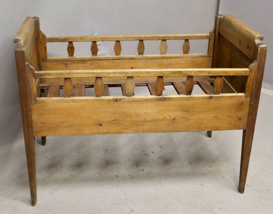 Antique children's bed from the 19th century.