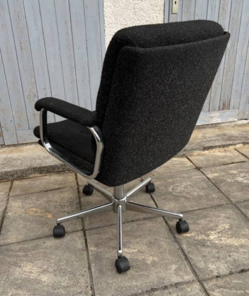 Black mottled fabric and chrome swivel armchair, 1