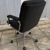 Black mottled fabric and chrome swivel armchair, 1