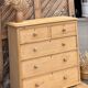 Large antique English chest of drawers in raw solid wood.