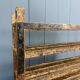 Old wooden workshop shelf with cast iron wheels.