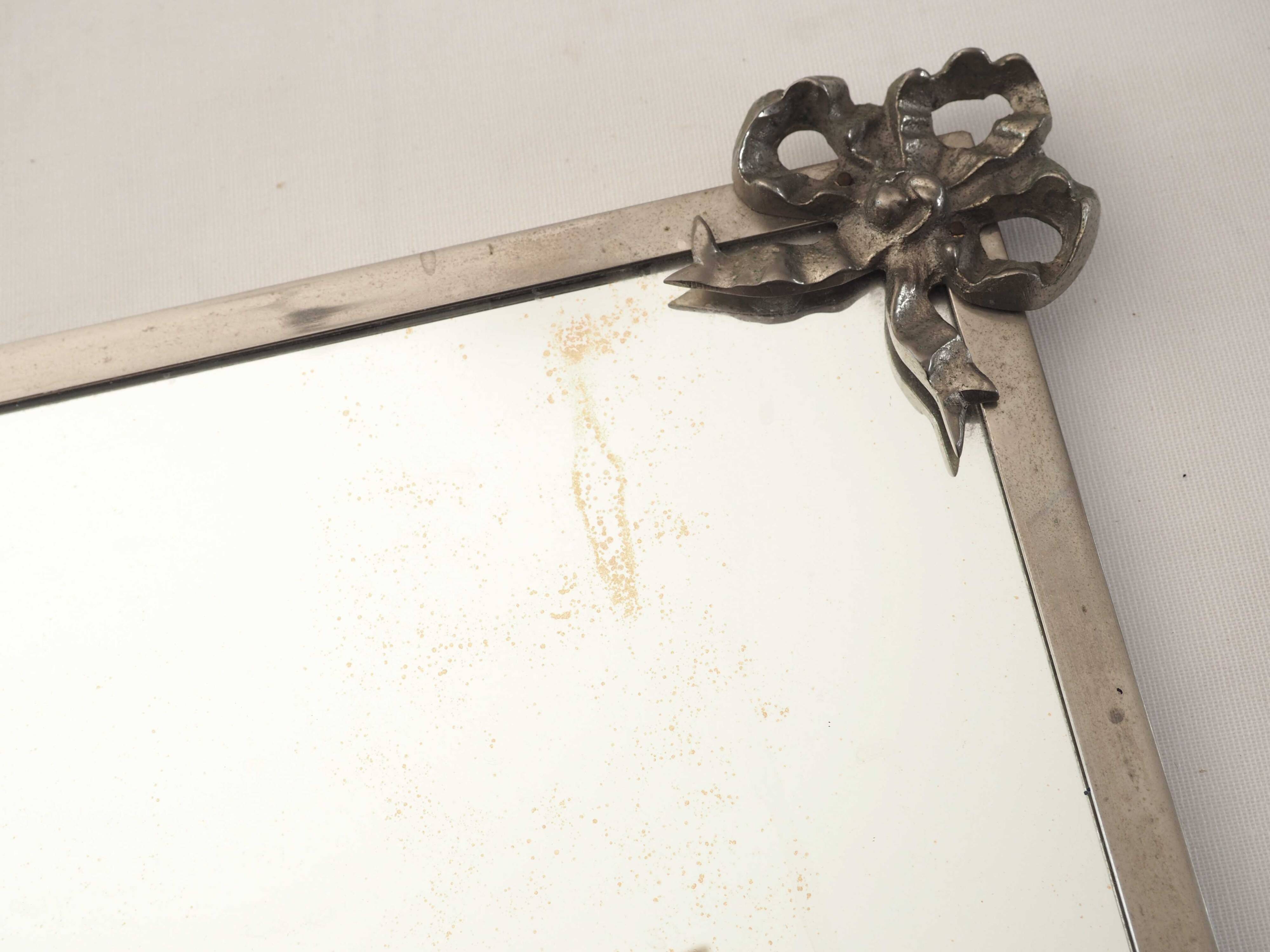 Antique mirror with silver metal rim