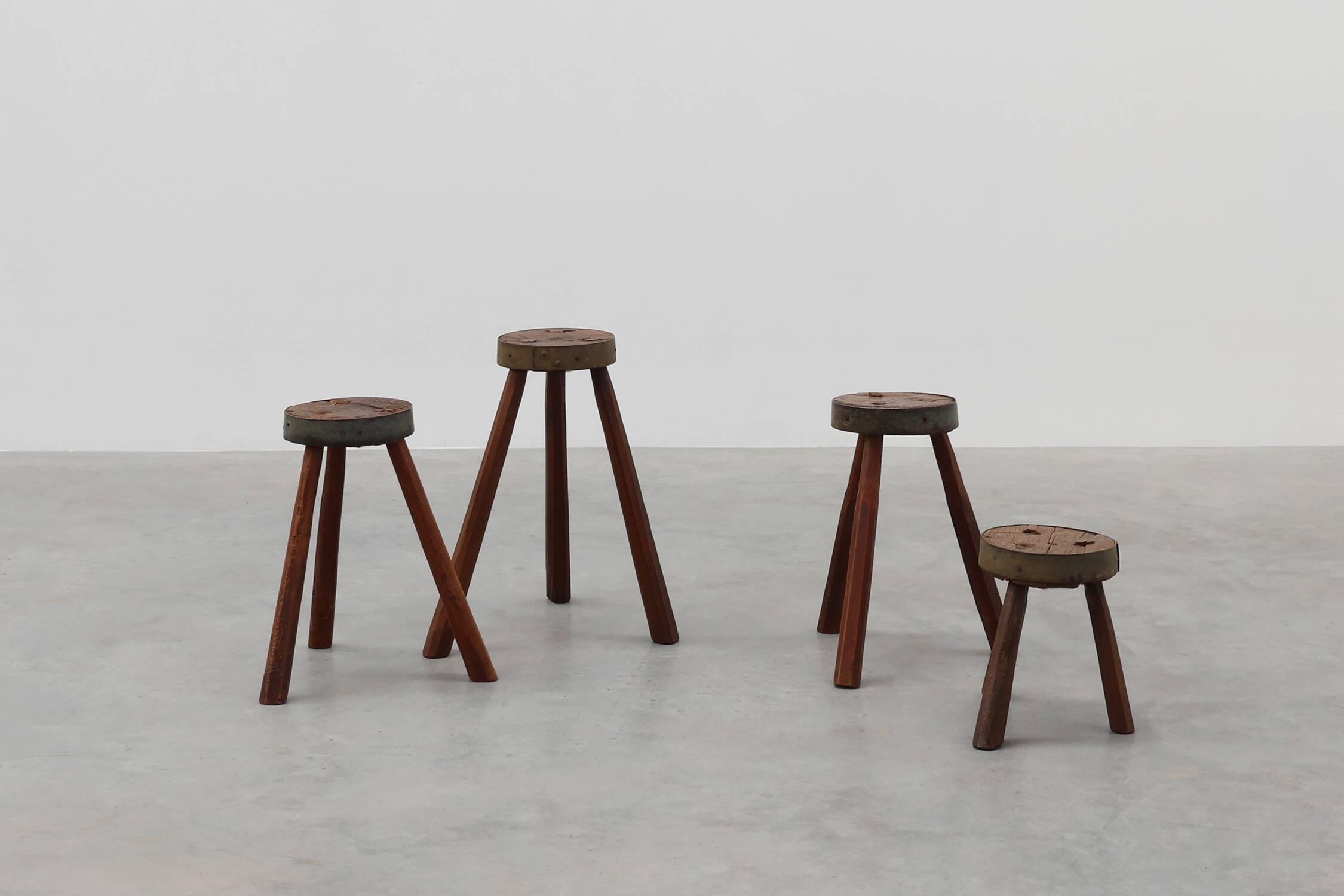 Brutalist French 1850s solid oak tripod stools with metal rim, set of 4