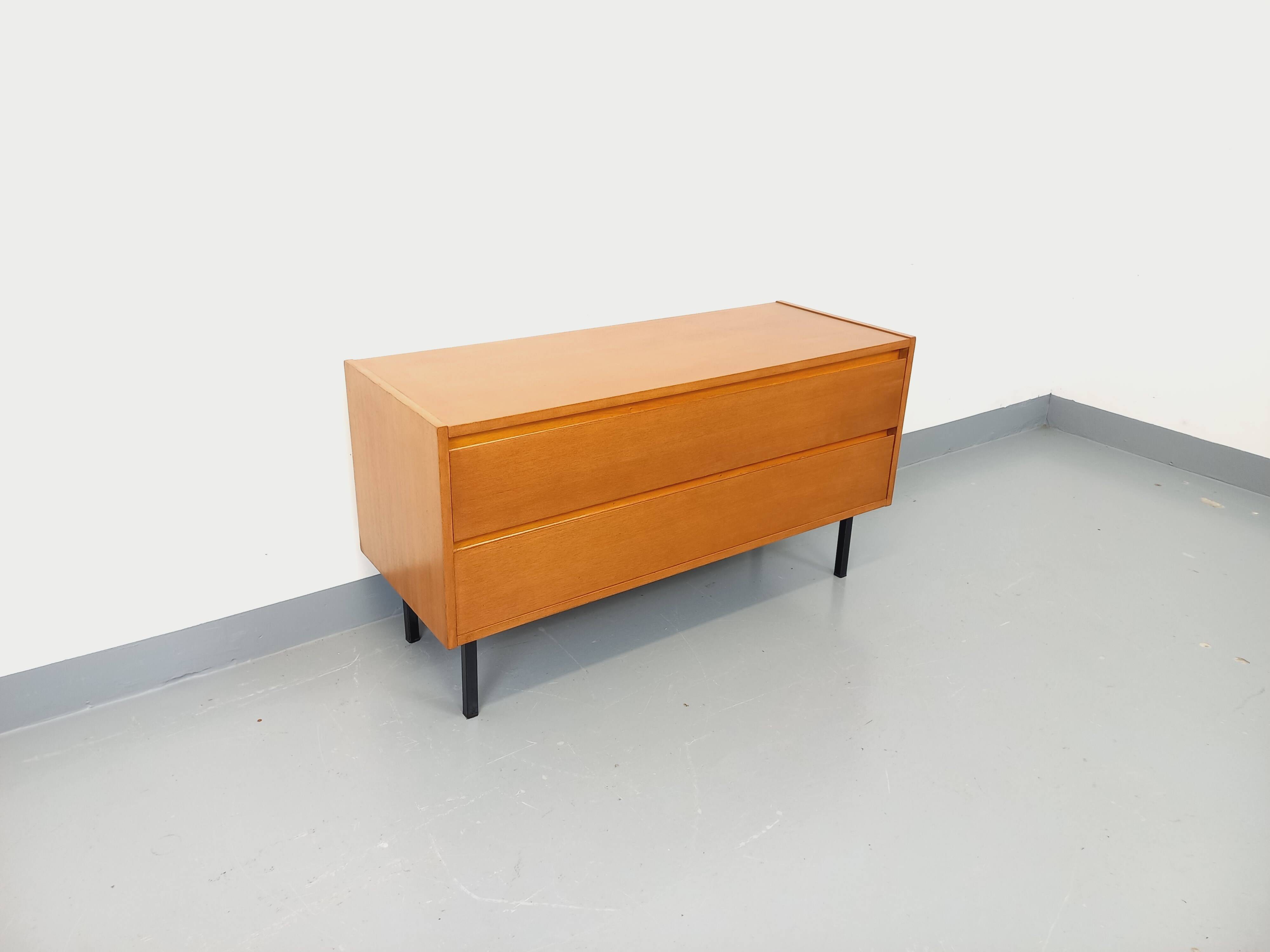 Small vintage Scandinavian sideboard in modernist style made of light oak wood.