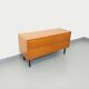 Small vintage Scandinavian sideboard in modernist style made of light oak wood.