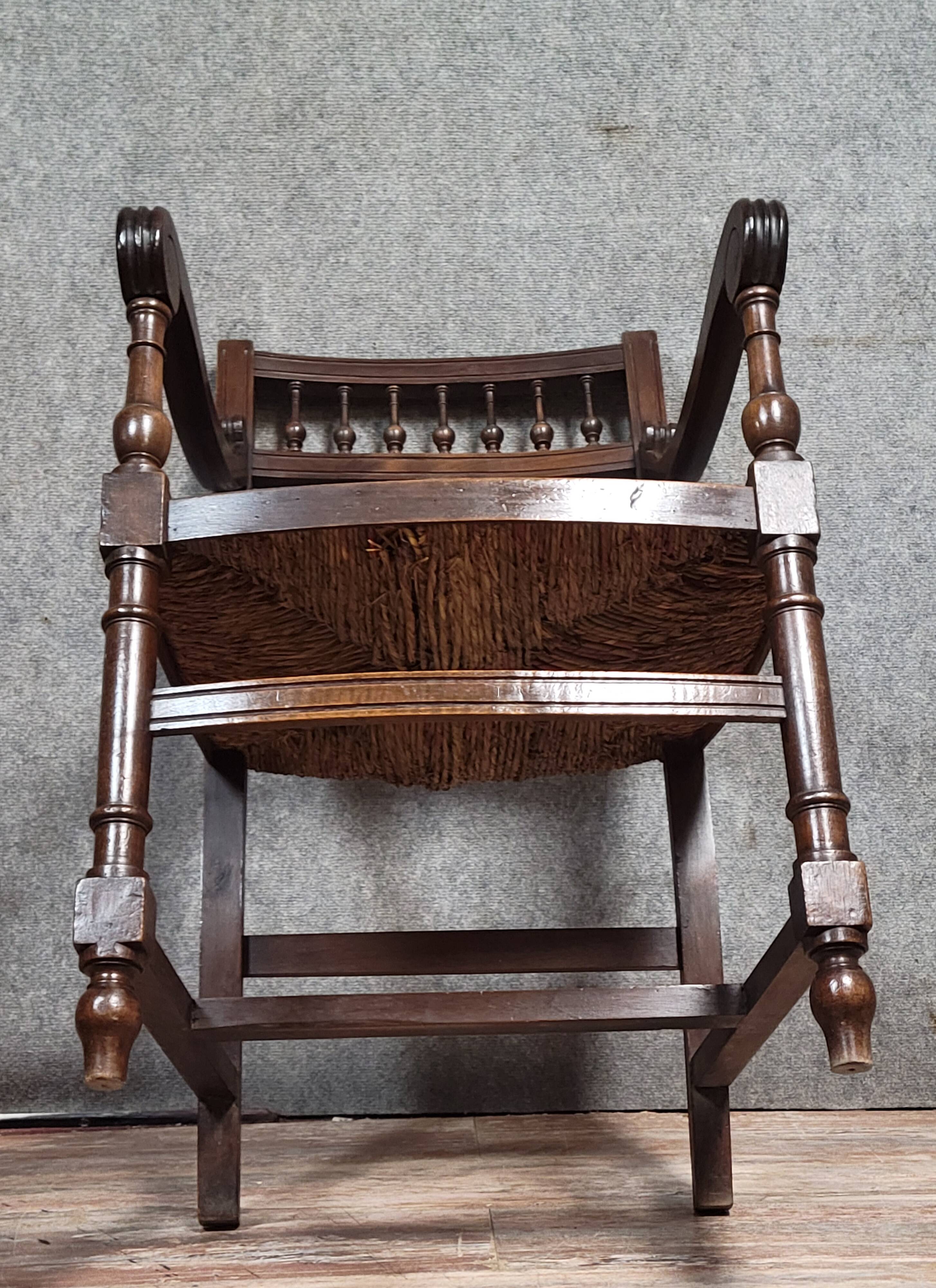 Renaissance-style armchair in solid wood, featuring a columned back