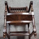 Renaissance-style armchair in solid wood, featuring a columned back