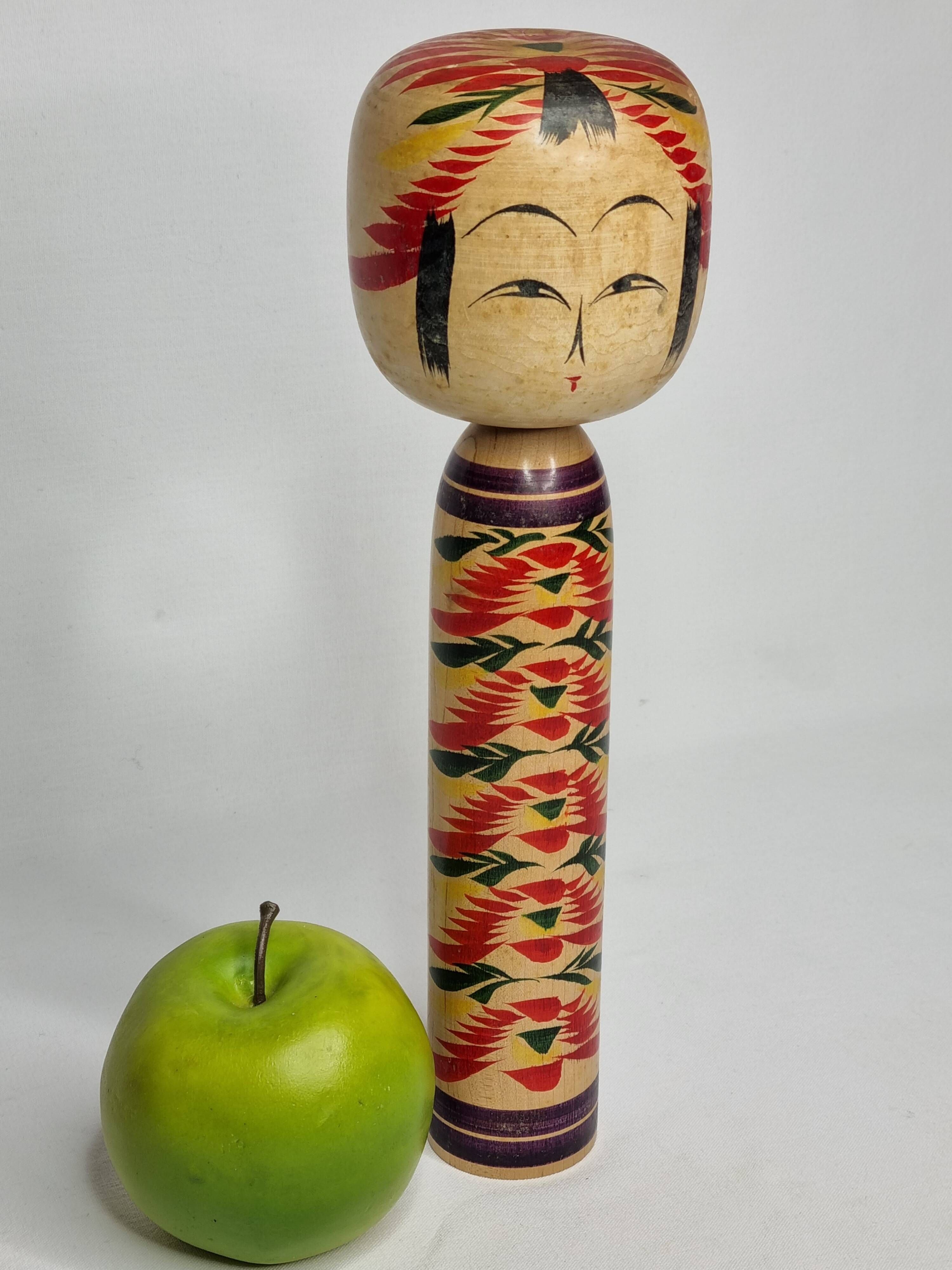 Japanese Kokeshi doll dated 1986, signed and numbered, hand-painted multi-colored floral decoration,