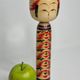 Japanese Kokeshi doll dated 1986, signed and numbered, hand-painted multi-colored floral decoration,
