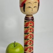 Japanese Kokeshi doll dated 1986, signed and numbered, hand-painted multi-colored floral decoration,